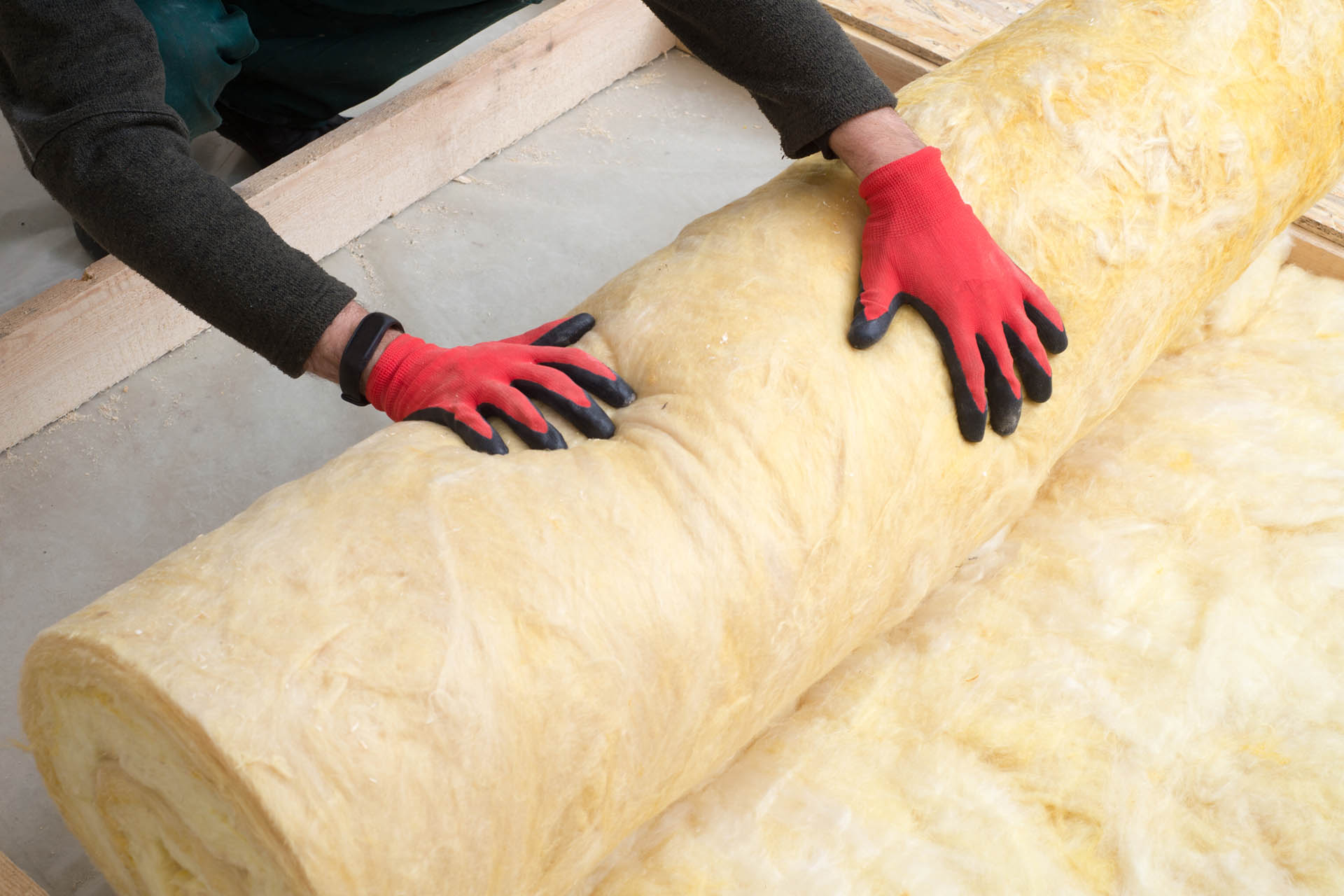 thermal-insulation-wool-rolls-worker-handling-building-materials